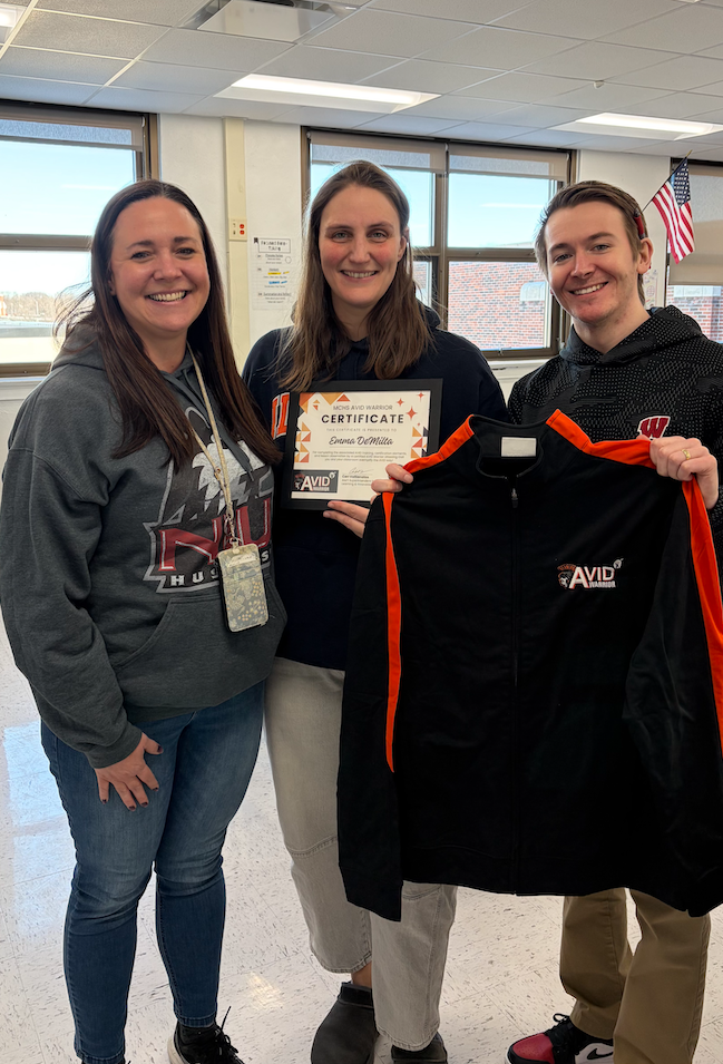 Emma DeMilta with award and coworkers