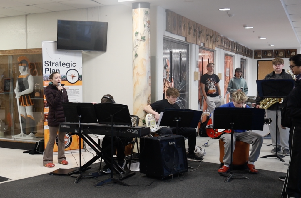 Band playing with a student singing 