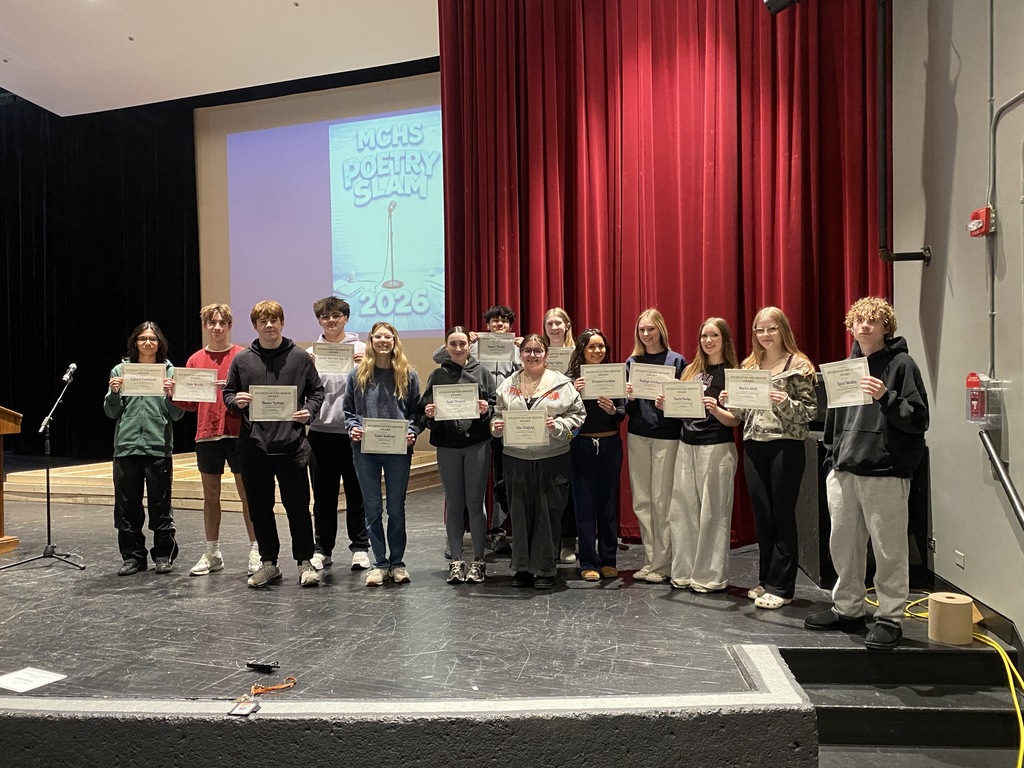 Group photo of students of the month holding their awards