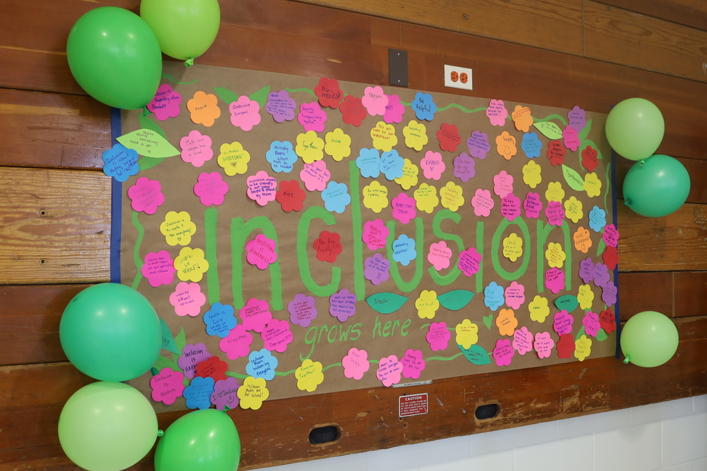 Inclusion wall: full of paper flowers of what inclusion means to people
