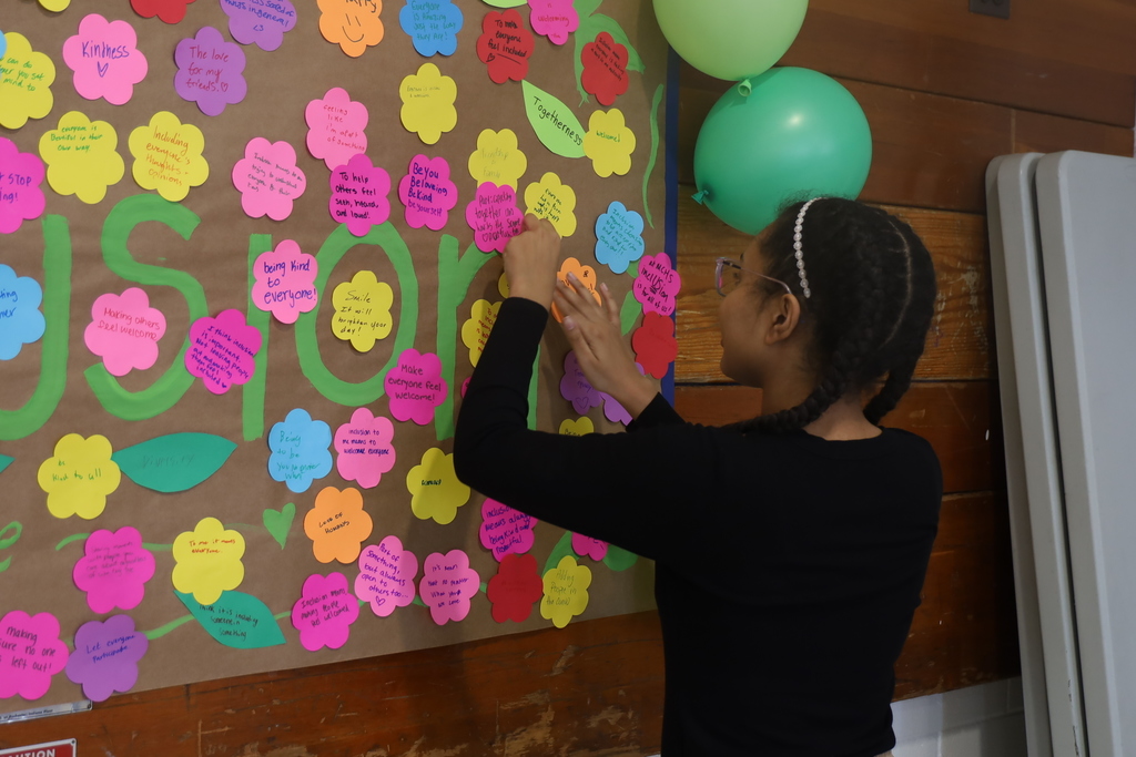Student hanging inclusion flower