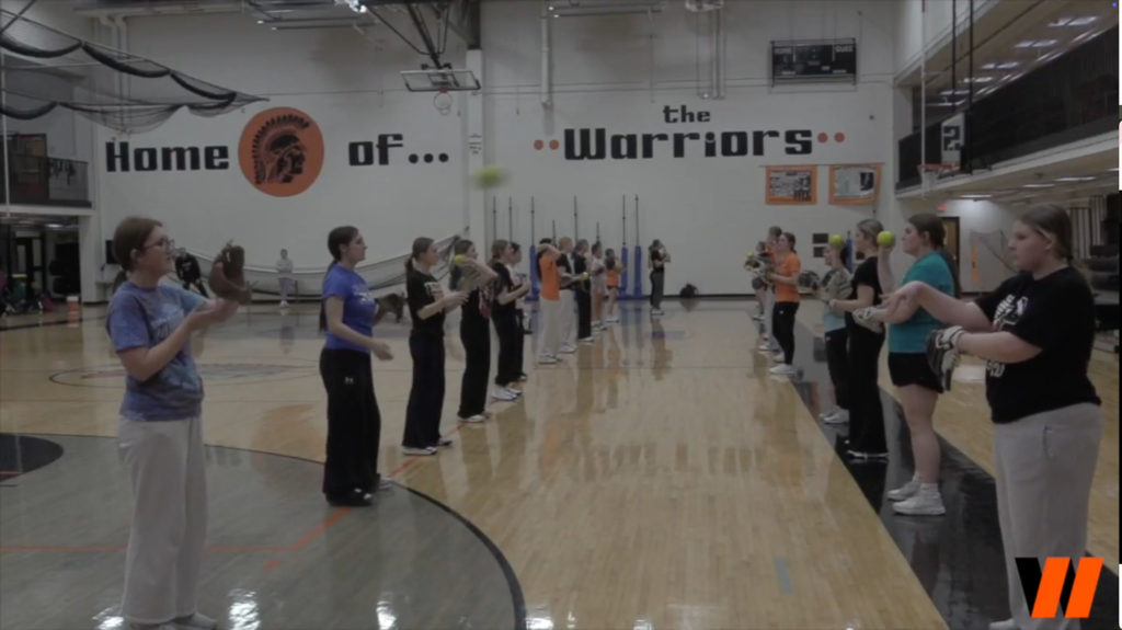 Softball students pitching to each other in practice 