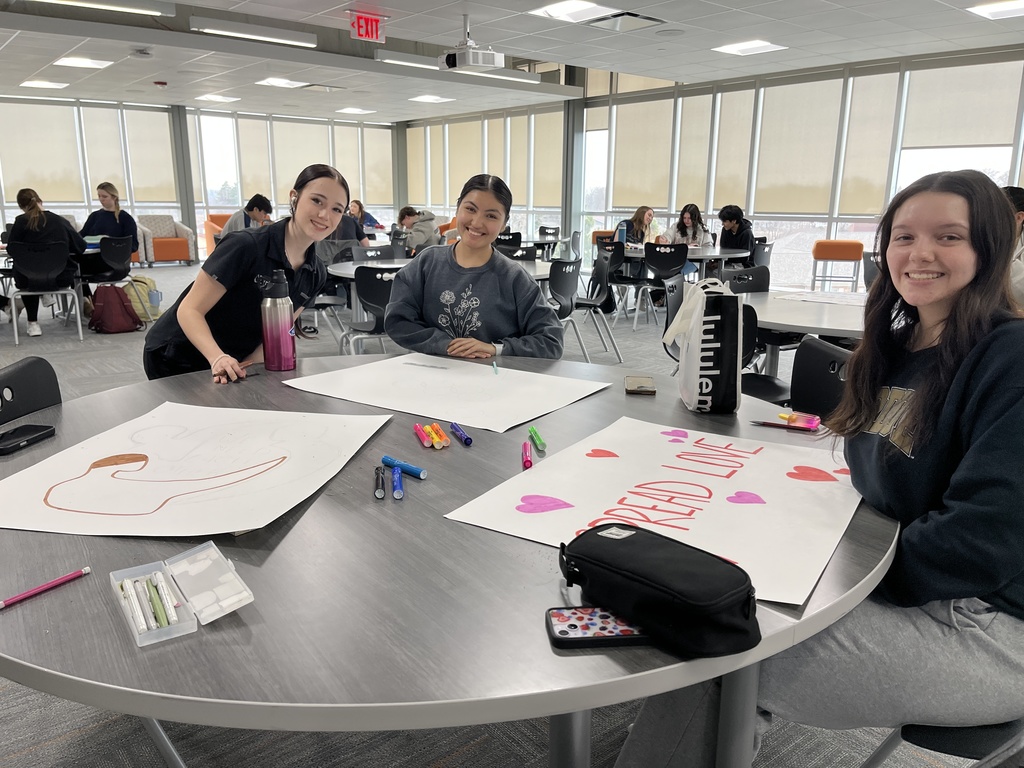 Studnets smiling and making posters