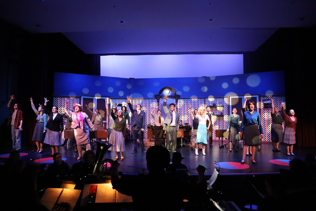 Full cast on stage dancing