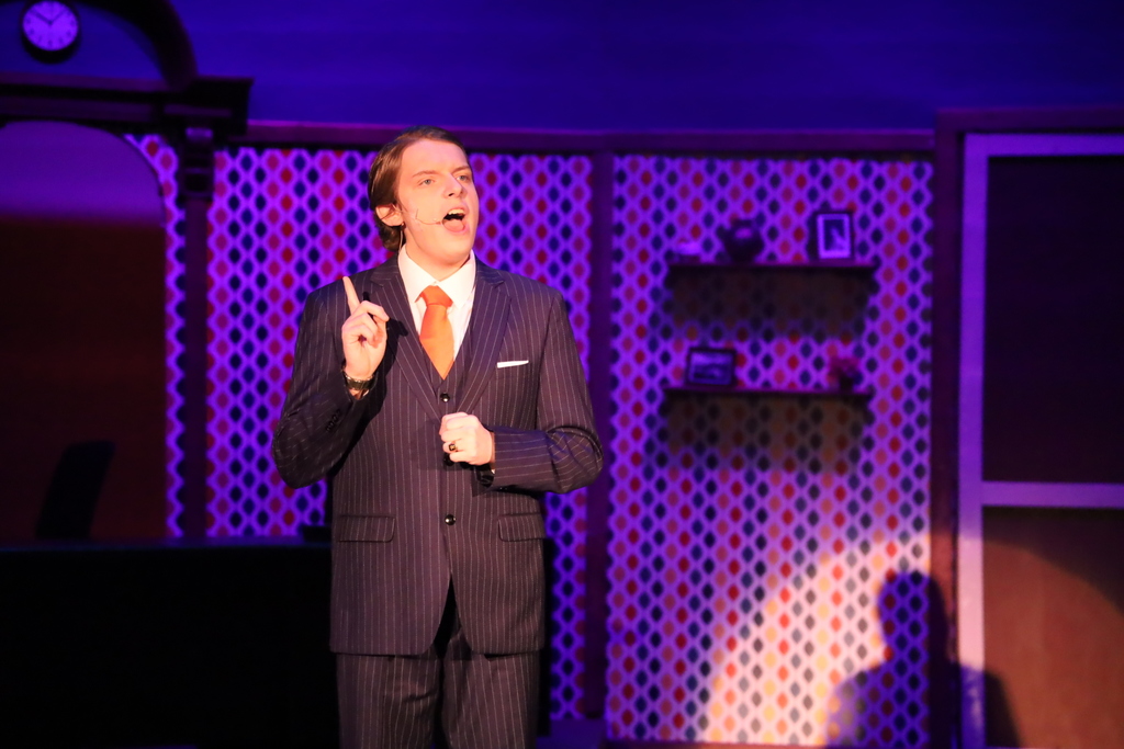 Male character in suit looking angry and holding up his pointer finger