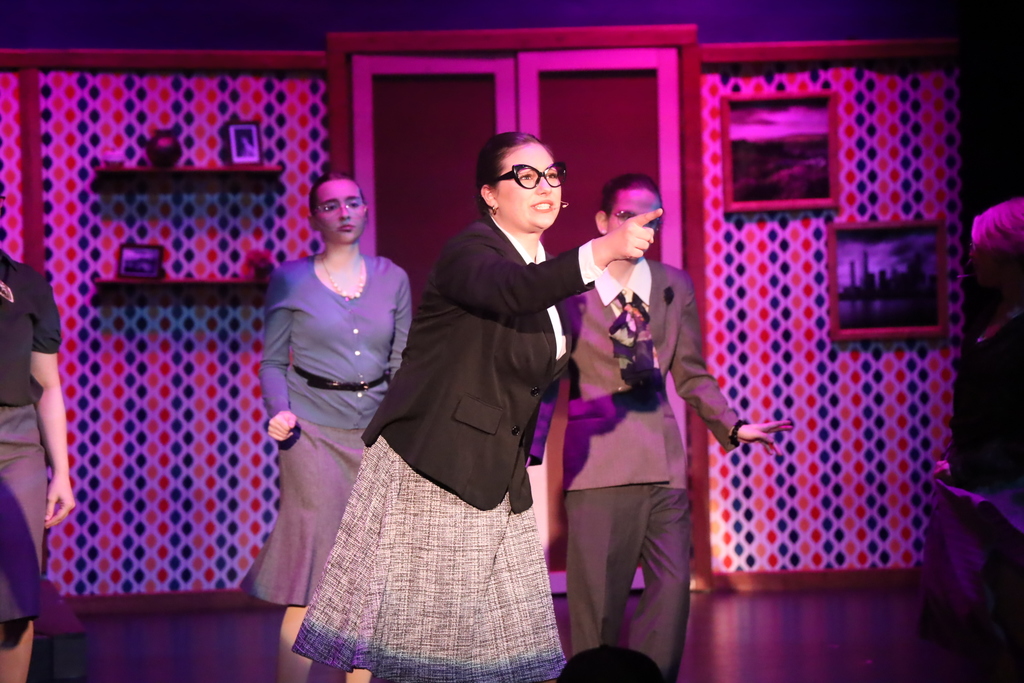 Student pointing while singing 