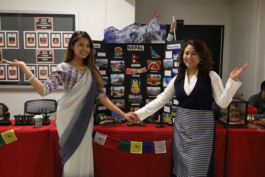 Women posing in front of Nepal booth