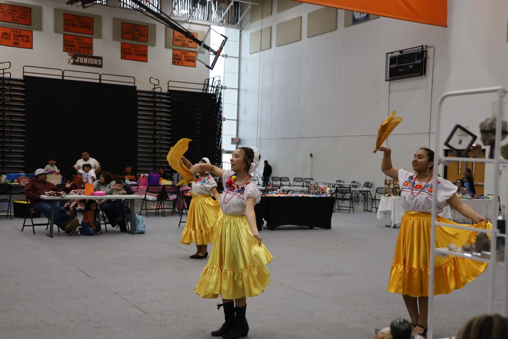 Women dancing in white and yellow dresses 