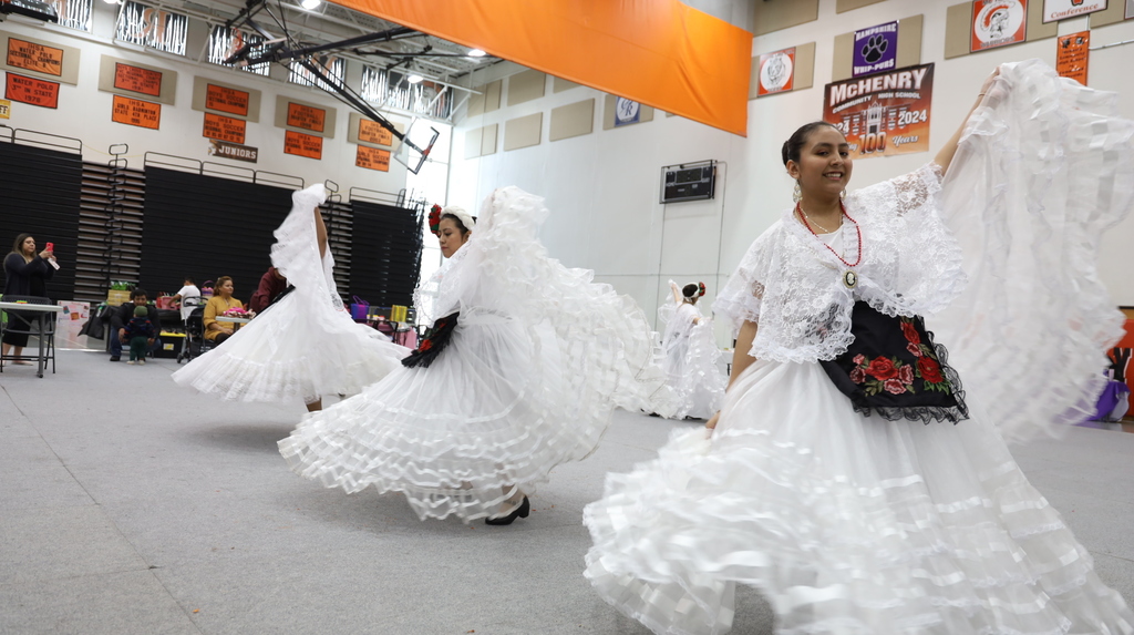 Women dancing in white dresses
