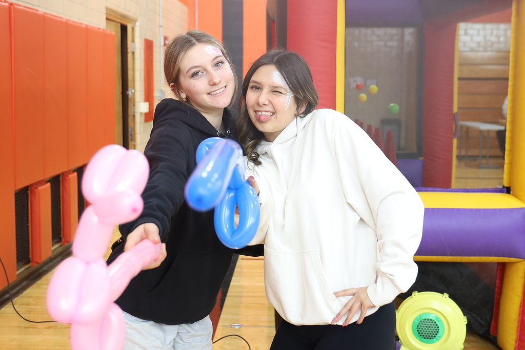 Two students with balloon animals