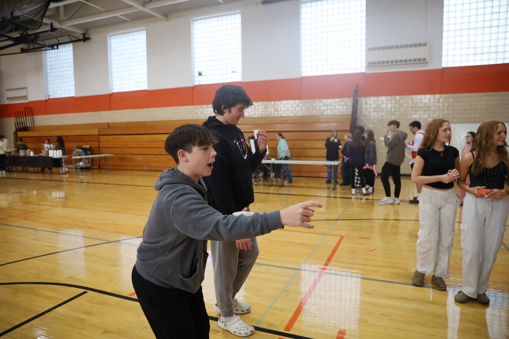 Student pointing and smiling