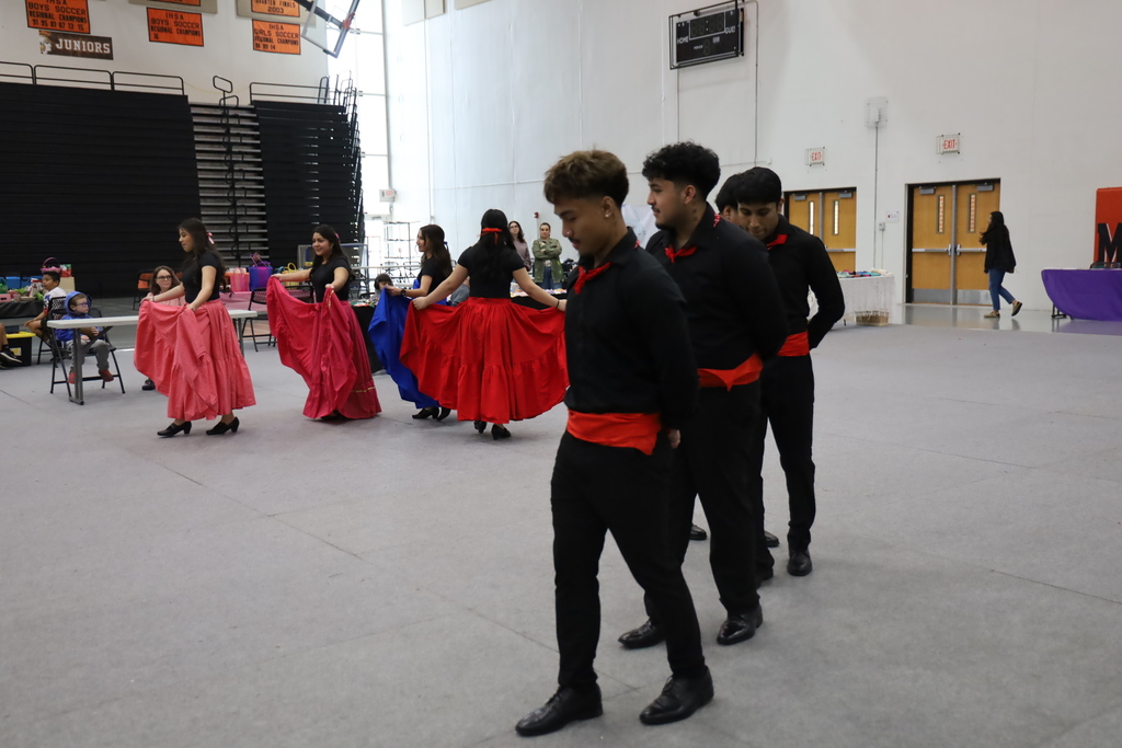 Students in cultural attire dancing