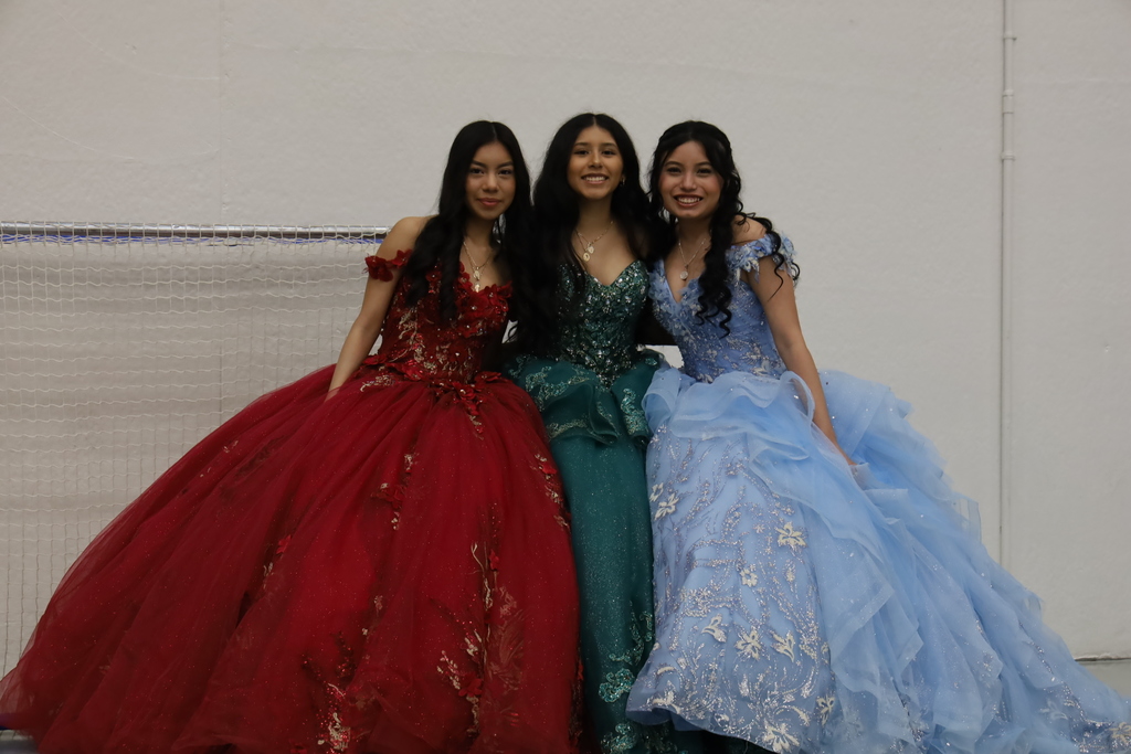 Three students in Quincenra dresses