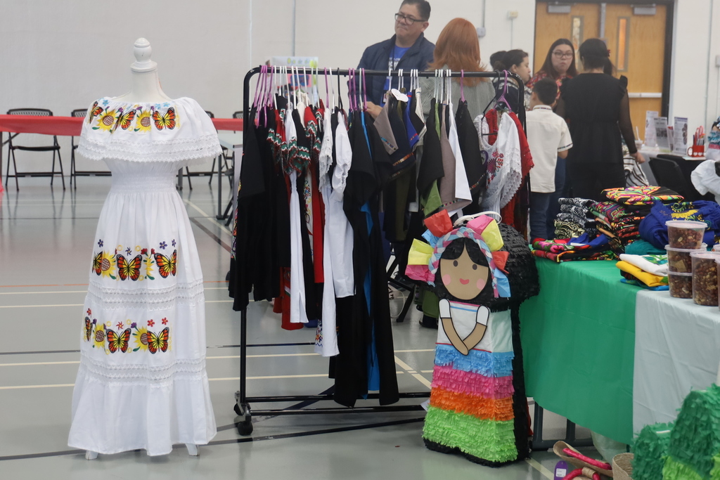 Cultural dress with pinata  next to it 