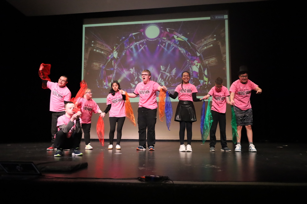 Students on stage bowing