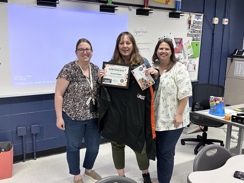 Annette Folden holding Avid certificate and jacket next to Kelleen Santoini and Megan Bennett
