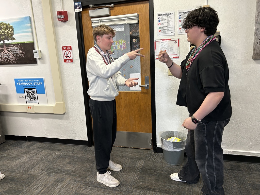Students rock paper scissors for beads