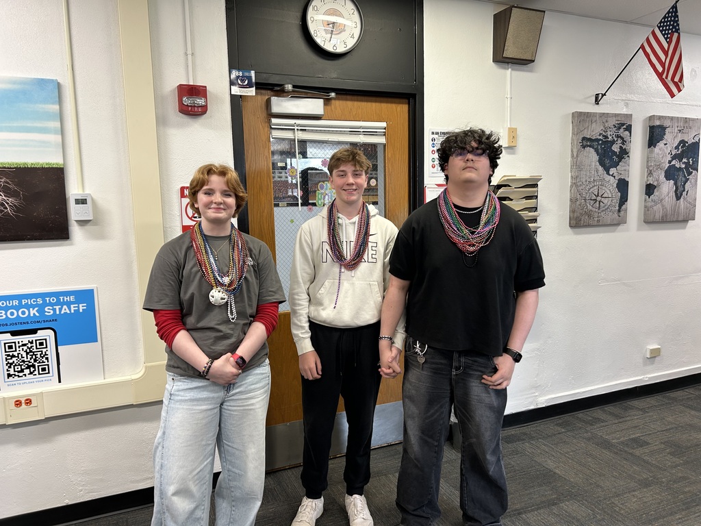 Three students wearing beads
