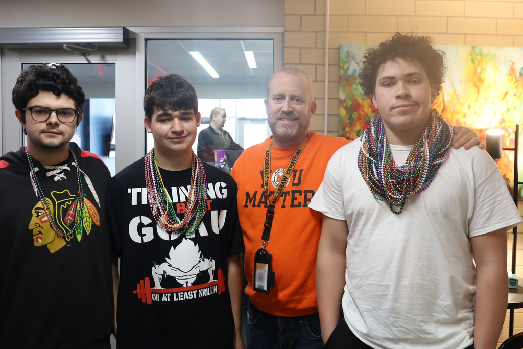 Principal Eiserman with students wearing beads