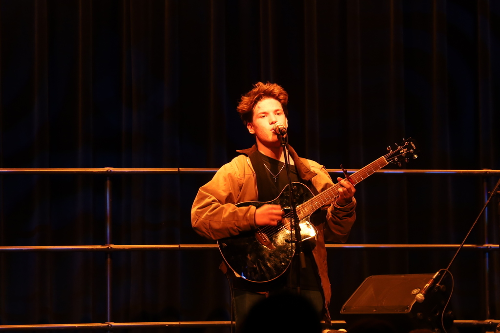Student singing with guitar