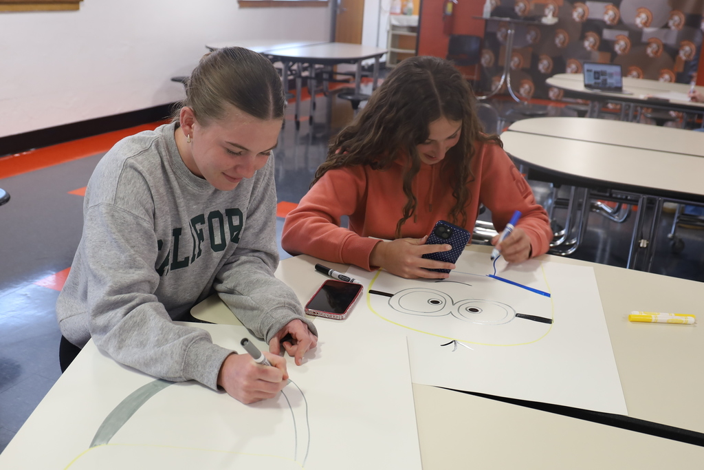 Students writing posters