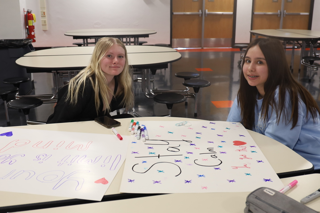 Students writing posters