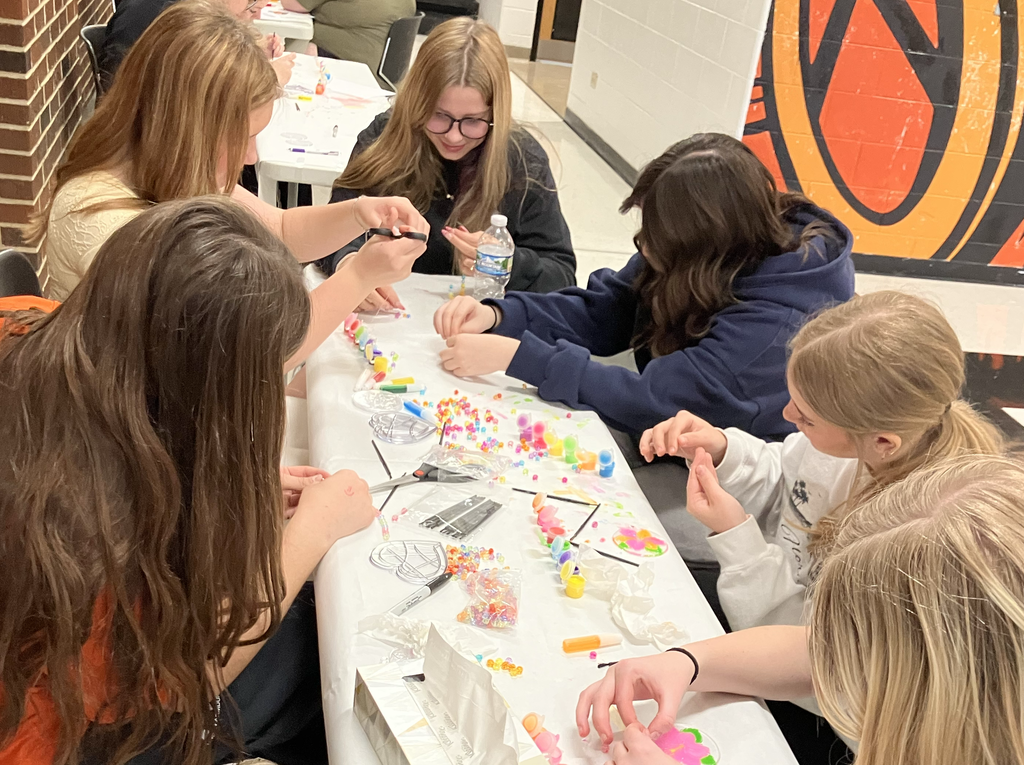 Students working on the sun catchers with paint