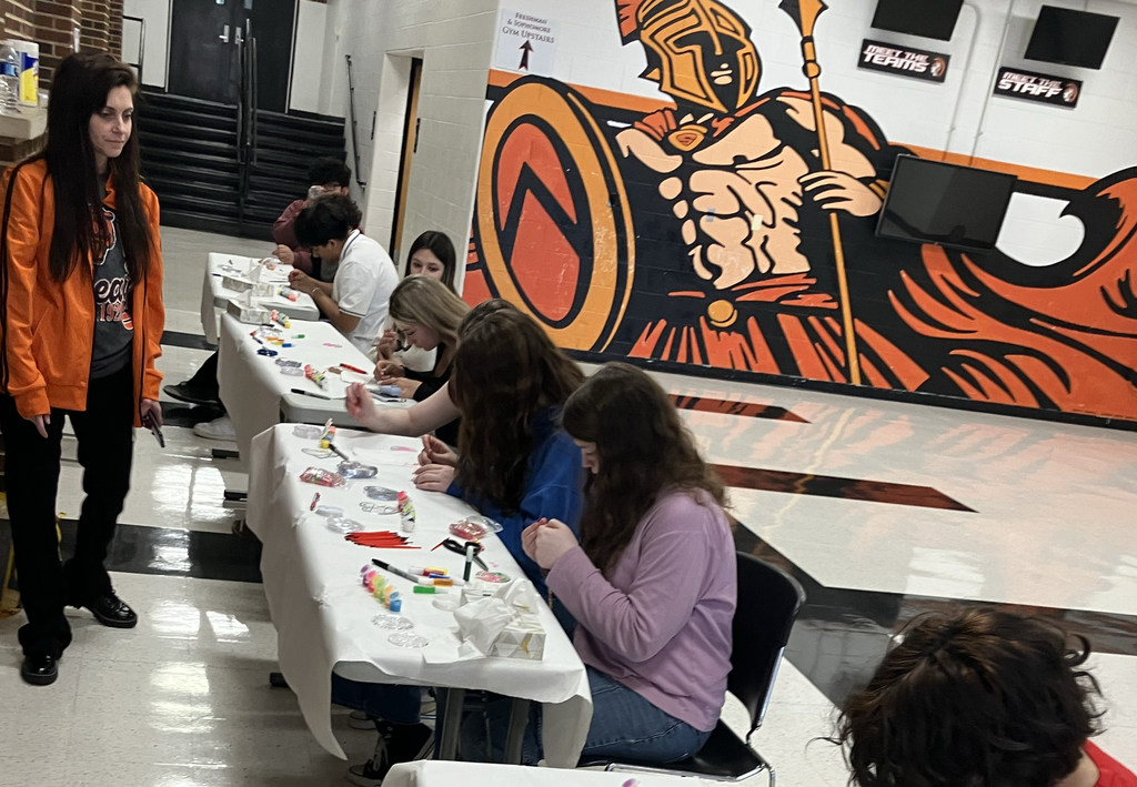 Students working on the sun catchers with paint