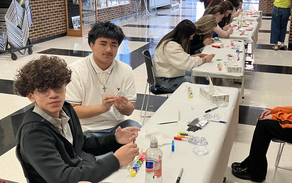 Students working on the sun catchers with paint