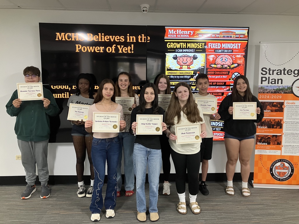 Group of students holding student of the month certificates