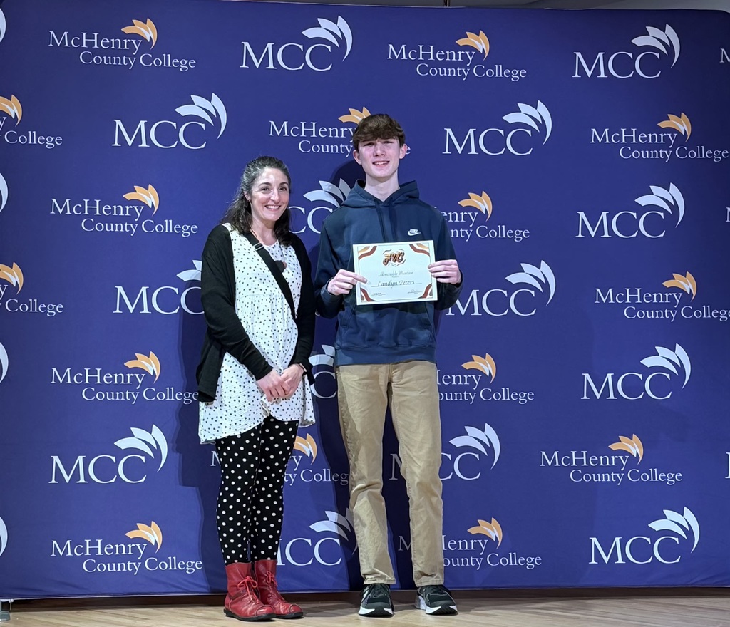 Landyn with his award and art teacher