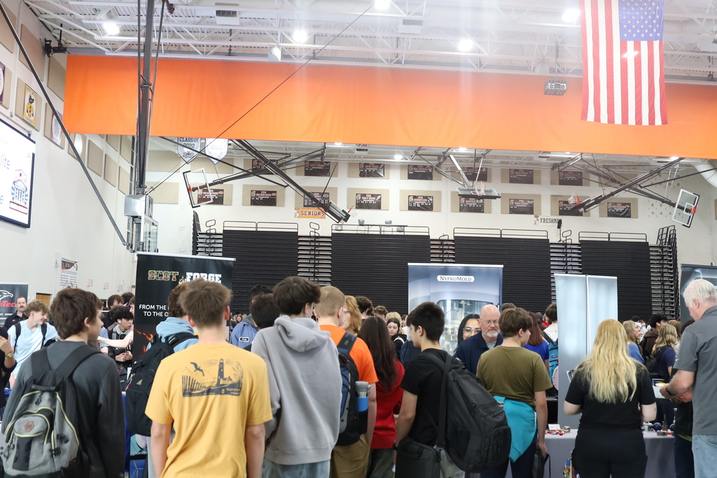 Students standing by representative tables