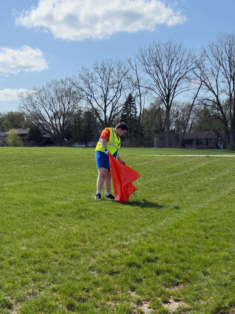 Student picking up trash outside
