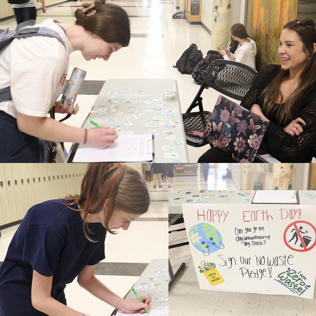 Two students singing a pledge. Sign that says "Happy Earth Day! Can you go one day without producing any trash? Sign our no waste pledge! I am zero waste" 