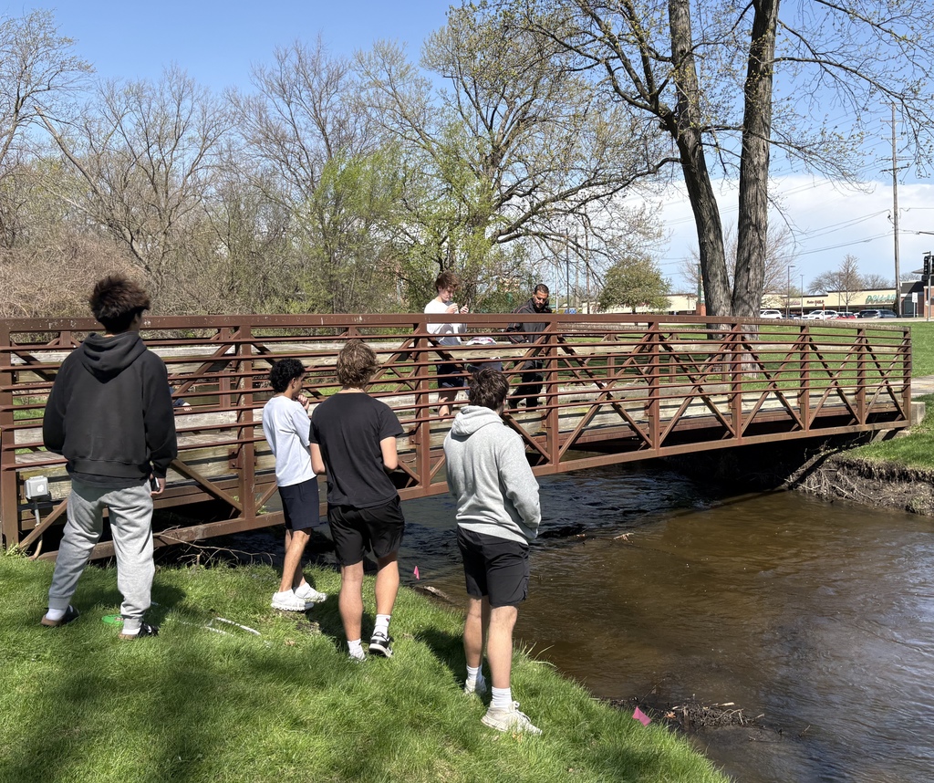 Students standing on the bridge by the river