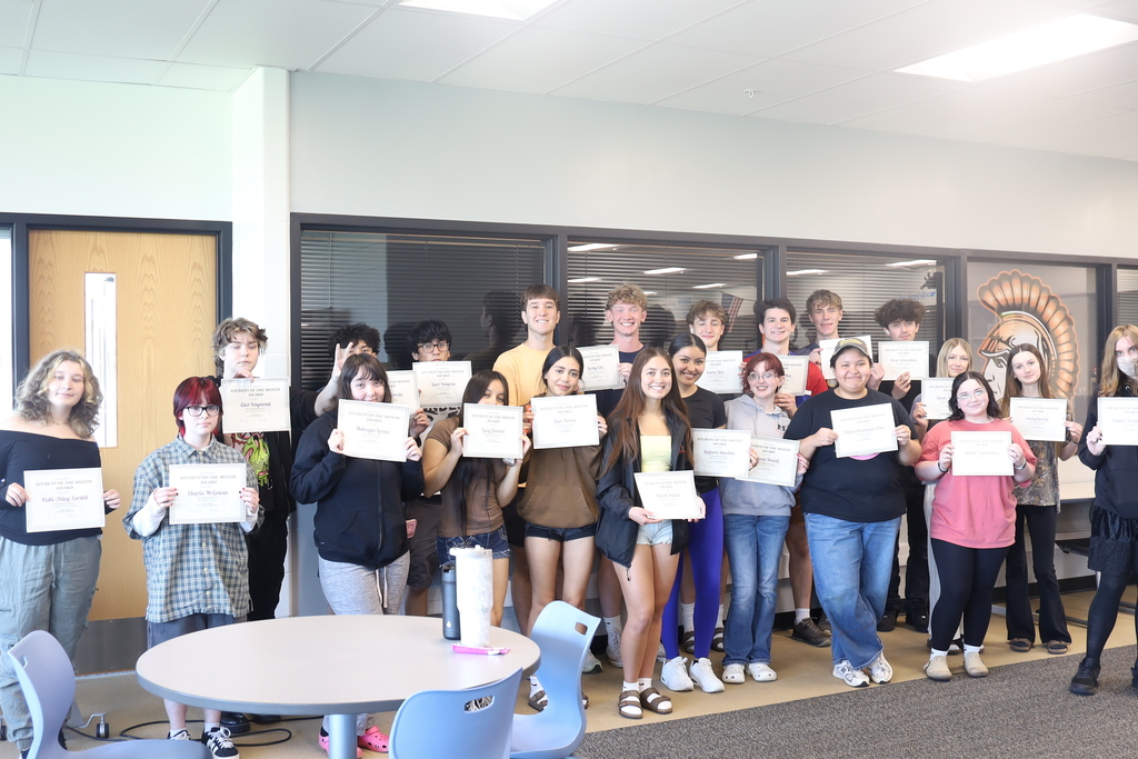 Around 20 students holding their certificates