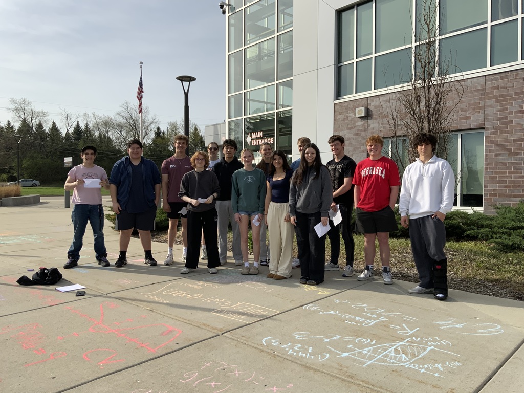 Students in front of sidewalk chalk with mathematical equations