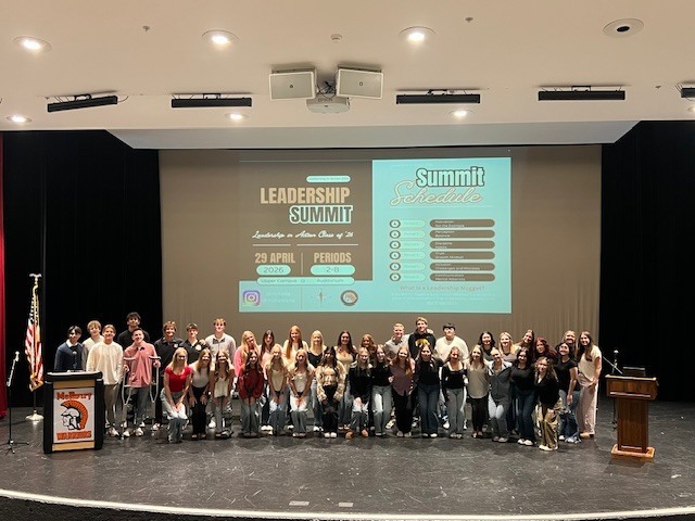 Group photo of Leadership Summit on stage