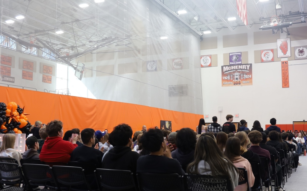 Students clapping with some seniors standing