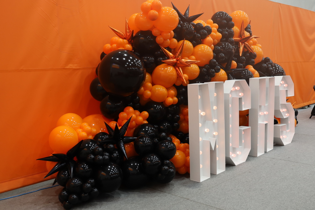 Orange and black balloons with big MCHS letters that light up 