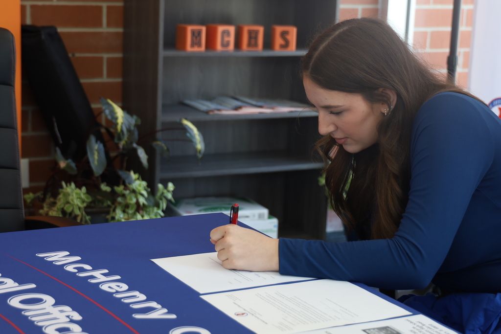 Kaitlyn signing a document