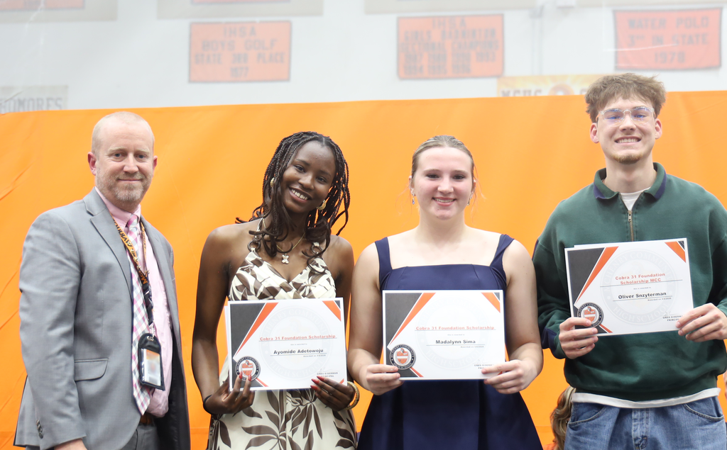 Principal with three students cobra 31 scholarship