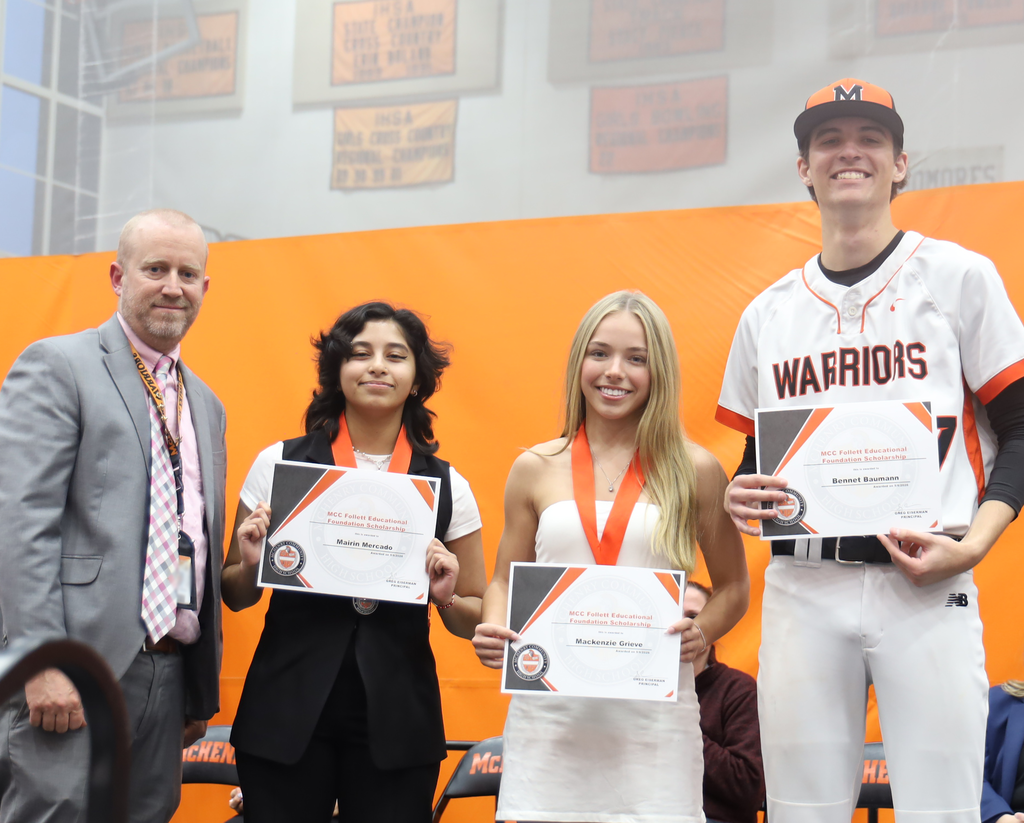 Principal with three students for the Follet Education Scholarship