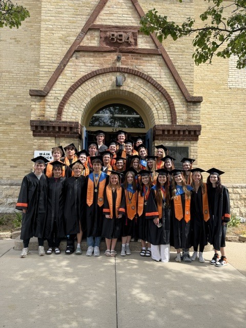 Students standing in front of Landmark