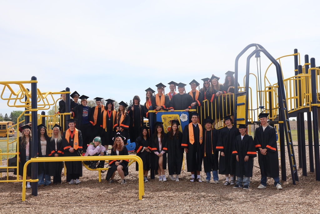 Students on playground in caps and gowns