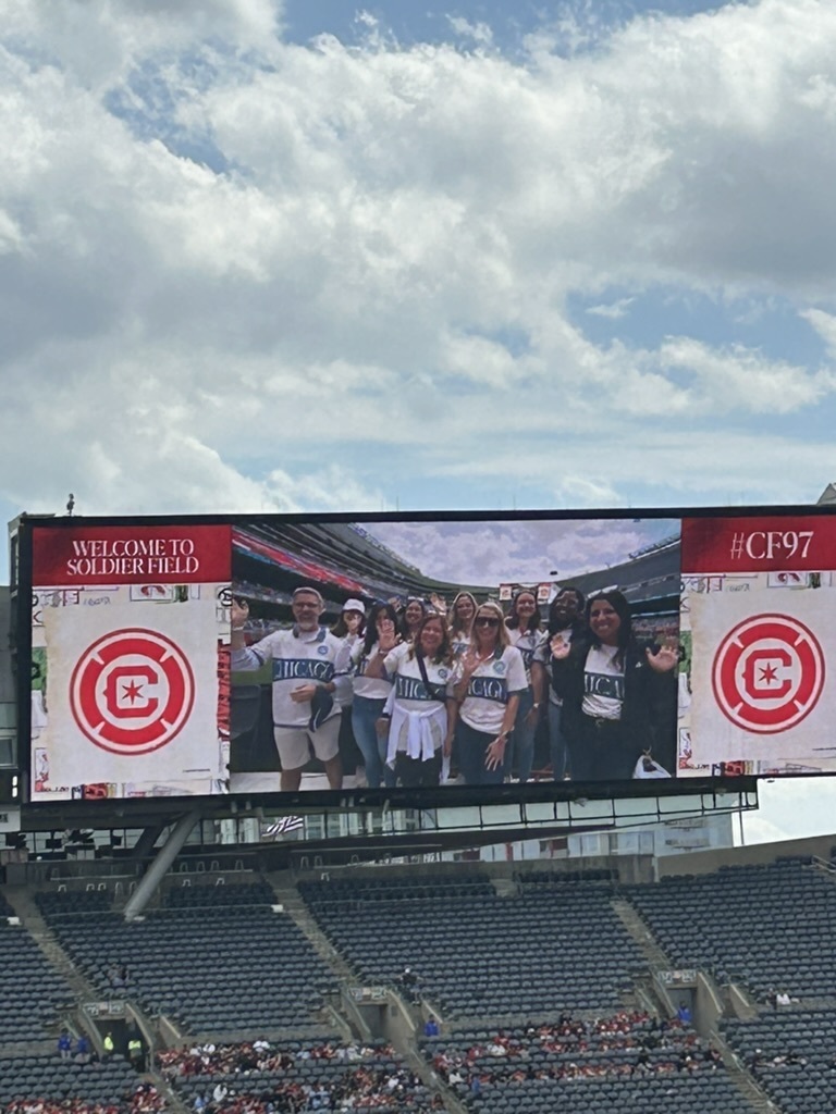 Teachers waving on the jumbo tron
