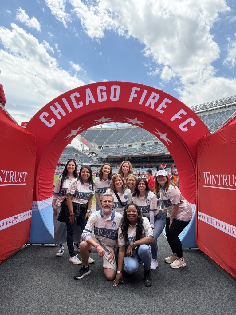 Group of teachers under Chicago Fire sign
