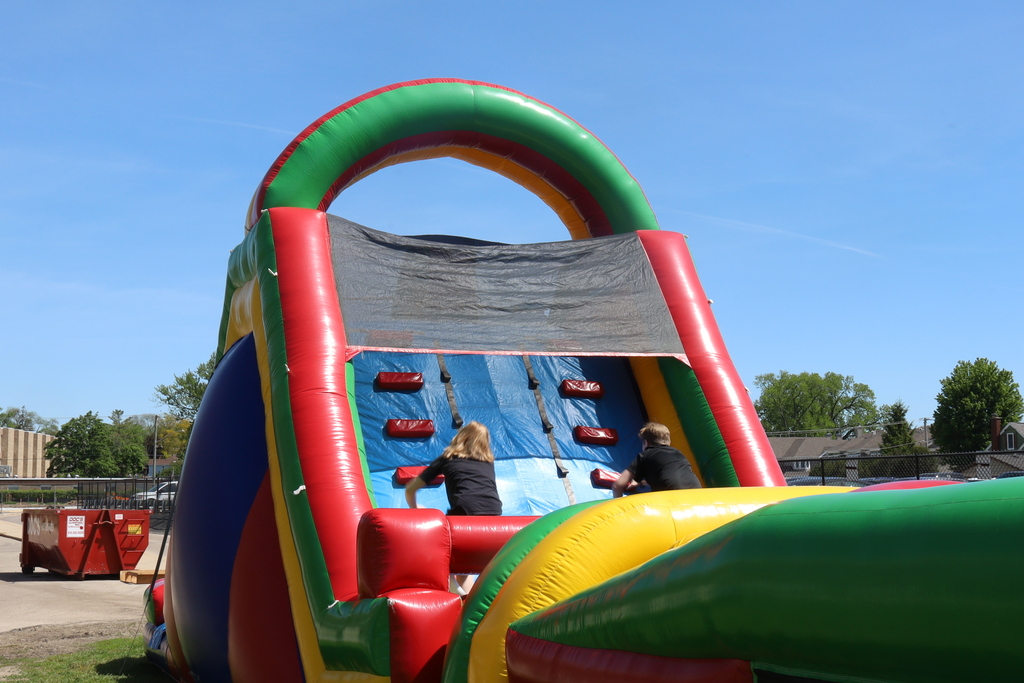Students climbing an inflatable slide 