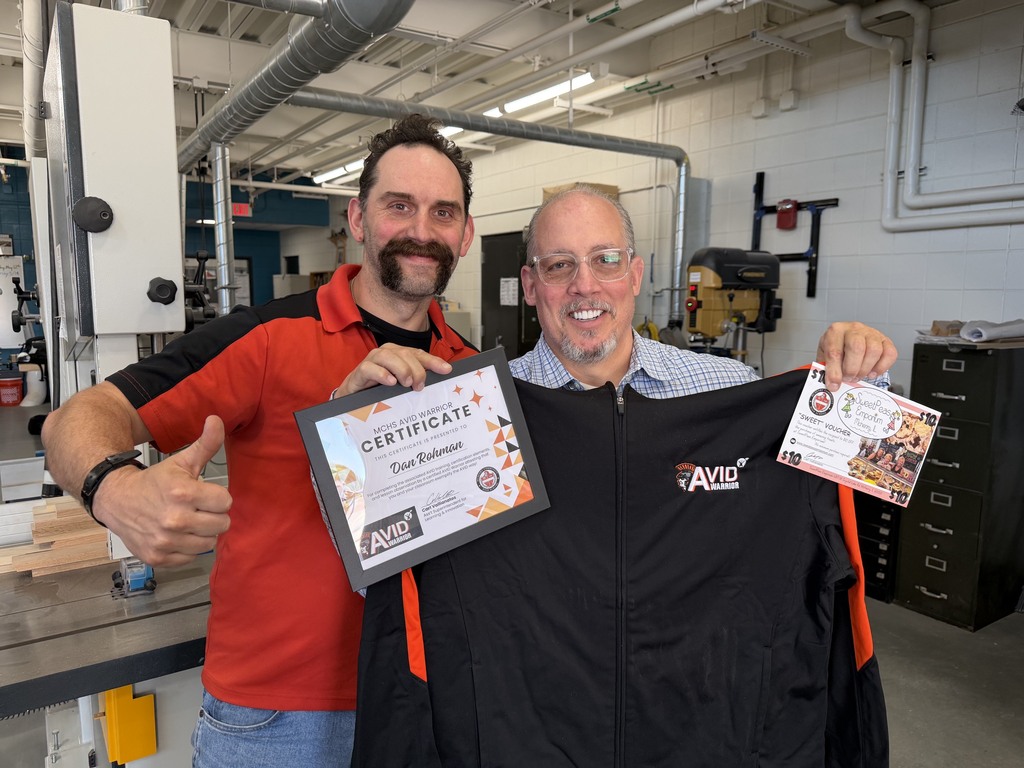 Dan Rohman with AVID certificate and jacket next to Ross Foley