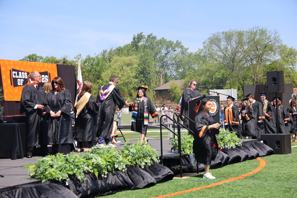 Students walking on the stage at graduation